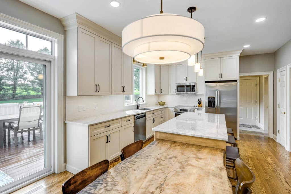 This kitchen renovation included custom cabinetry, quartzite countertops, picket style backsplash tiles, and new hardwood floors, but the custom live edge table stole the show! It was the perfect compliment to the classic clean lines of the rest of the kitchen.