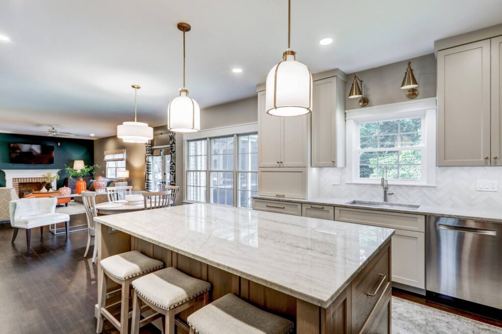 This is a professional photo for a kitchen remodel in Hershey, PA. This includes new lighting, a kitchen island, additional countertop space, tile backsplash, and more.