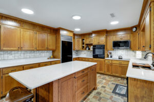 This is a wooden kitchen remodel that includes a kitchen expansion, kitchen island replacement, and tilework.