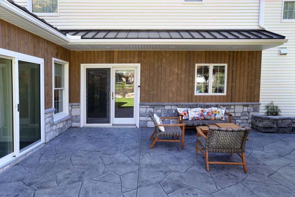 Major exterior renovations in Lancaster, PA with stamped concrete, an outdoor kitchen, and a four-seasons room addition
