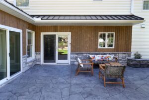 Major exterior renovations in Lancaster, PA with stamped concrete, an outdoor kitchen, and a four-seasons room addition