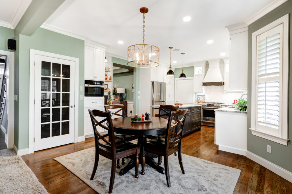 Kitchen remodel design with small dinner table and quartz kitchen island.