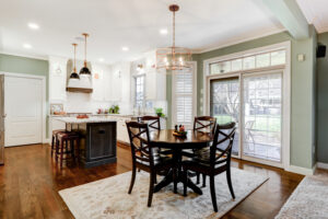Kitchen remodel design with small dinner table and quartz kitchen island.